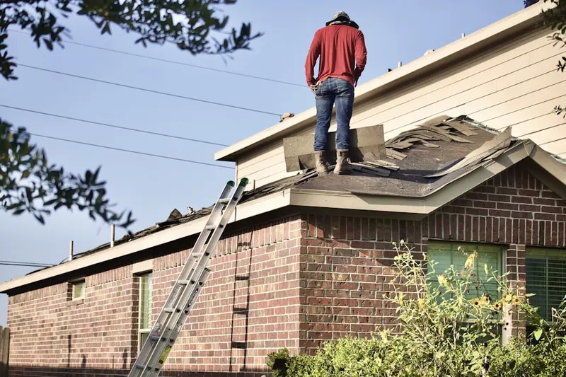 Professional roofer working on a residential roof in Crofton Commons